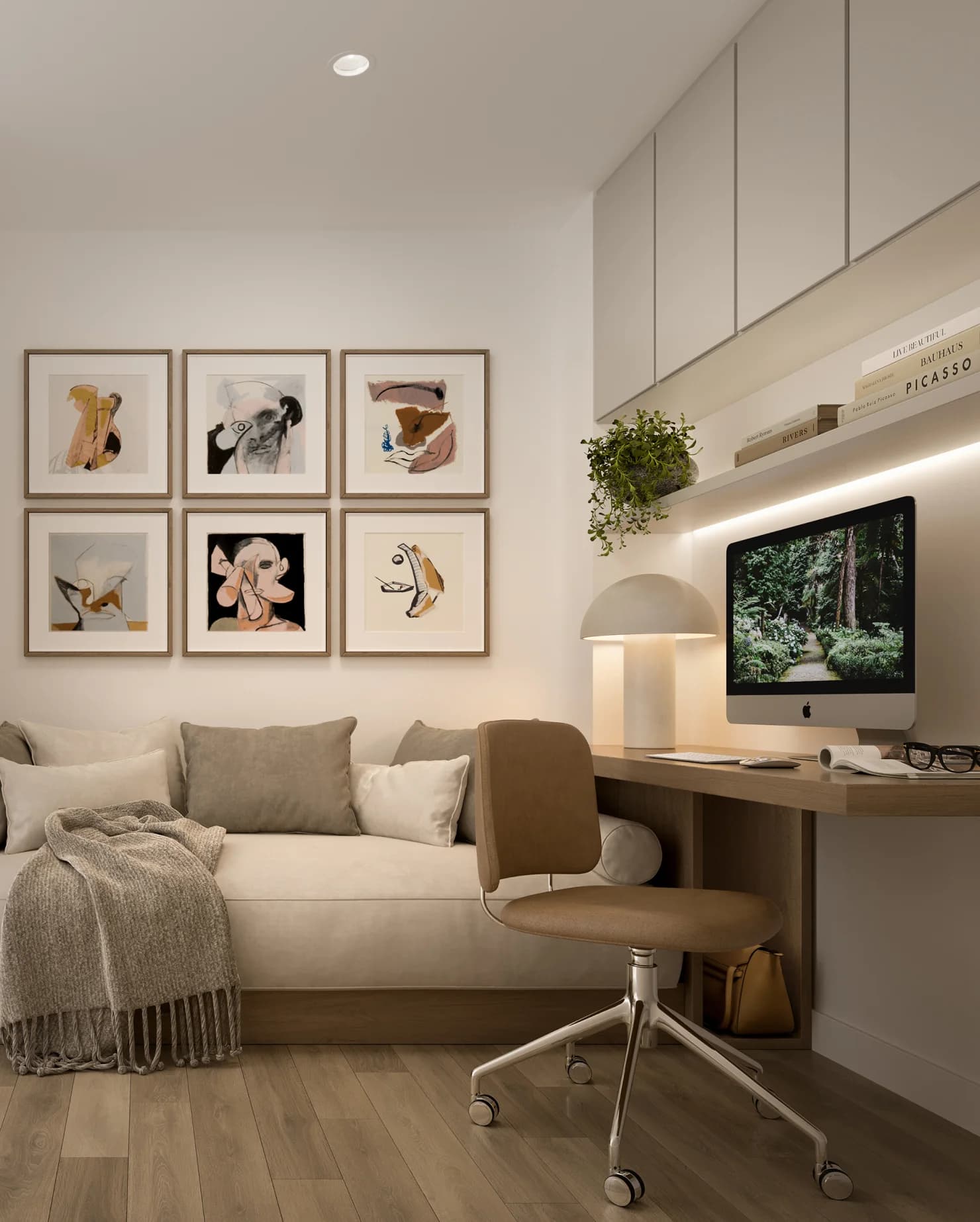 An Ironwood den: a sofa with cushions and a throw, a built-in desk and a wall of framed art
